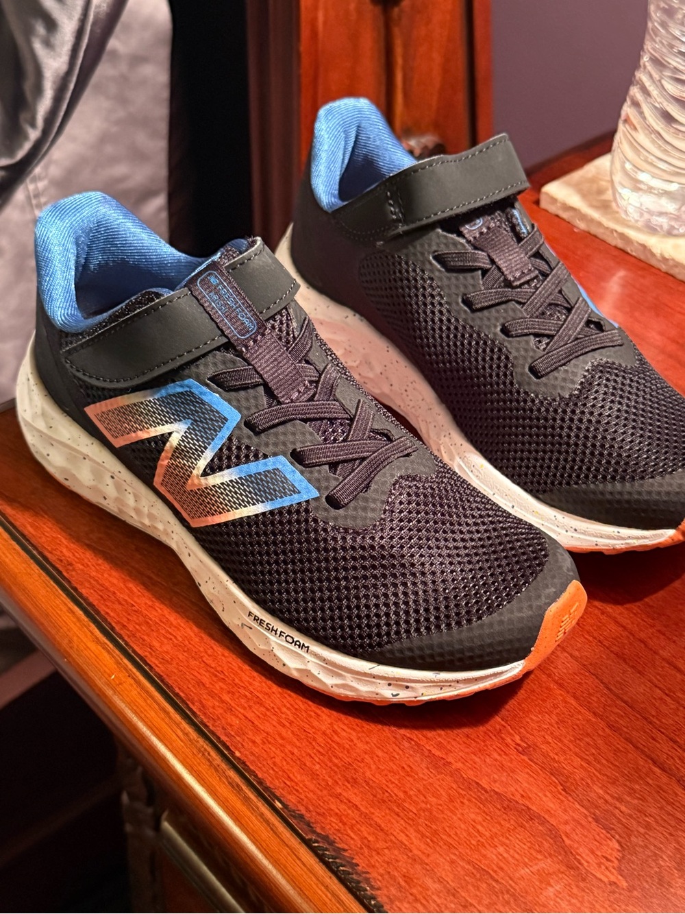 New Balance Kids Black Sneakers with Blue and Orange Accents